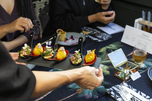 Botanical canapés served on black spoons