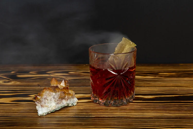 An amber spirit in cut crystal with honeycomb and a citrine crystal