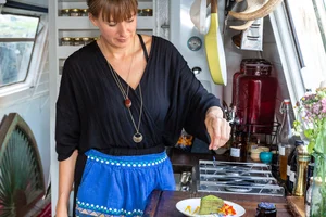 Jemma Foster preparing food aboard the boat