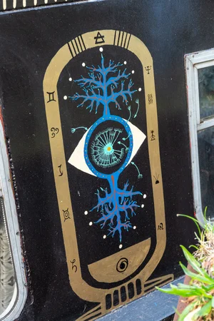 Painted panel of an eye and tree of life in gold and blue